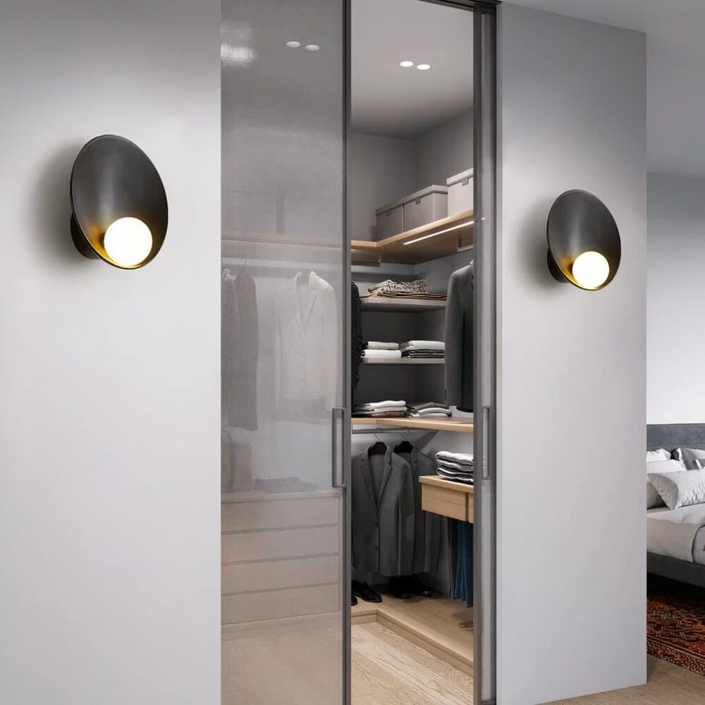 Two Scandinavian-style wall lights at the entrance to a dressing room