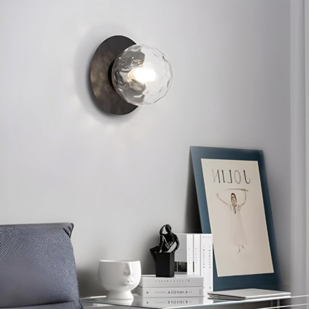 Wall light with blurred-effect ball hanging above a desk and next to a sofa
