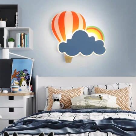 Wall lamp in the shape of a hot-air balloon and cloud hanging on a wall above a bed in a child's bedroom