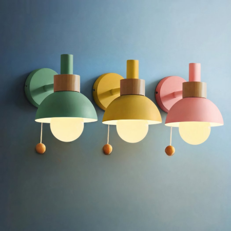 Three industrial wall sconces in metal and wood, each in a different color: green, yellow and pink, hung on a blue wall