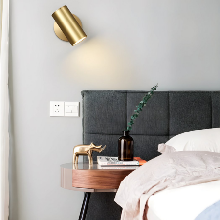 Gold-plated tube wall light with adjustable angle for hanging in a bedroom