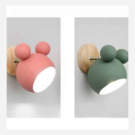on a gray background, two Scandinavian Mickey style wall lights, one pink and the other green