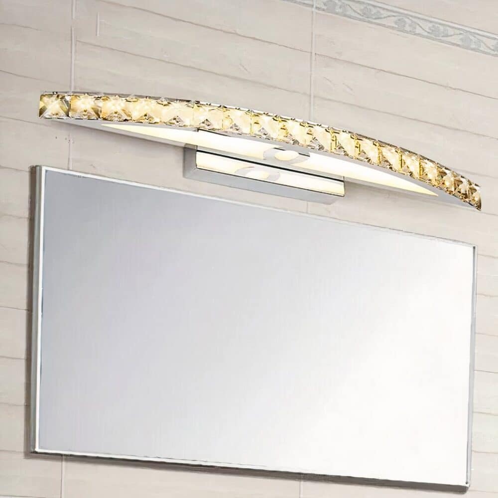 we see in a bathroom above a mirror a golden crystal style wall light for bathroom