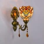 we see a tiffany-style wall lamp in orange tones on a light grey wall