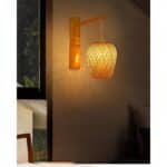 we see a wall sconce in hand-woven bamboo cane on a light wall at night