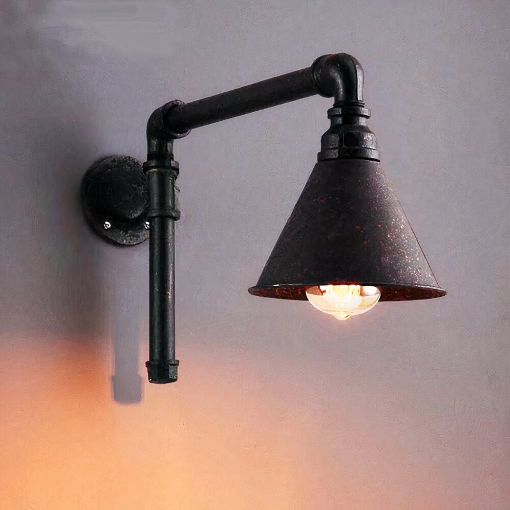 a pipe-shaped wall light in the industrial style is screwed onto a wall