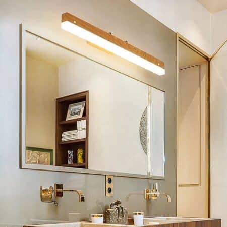in a bathroom, above a large mirror, we see a minimalist wooden rotating wall light