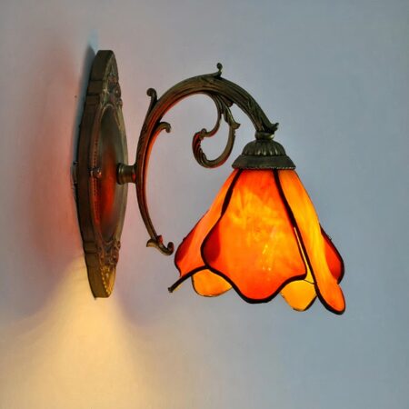 we see an orange hanging flower-shaped wall sconce in the Tiffany style