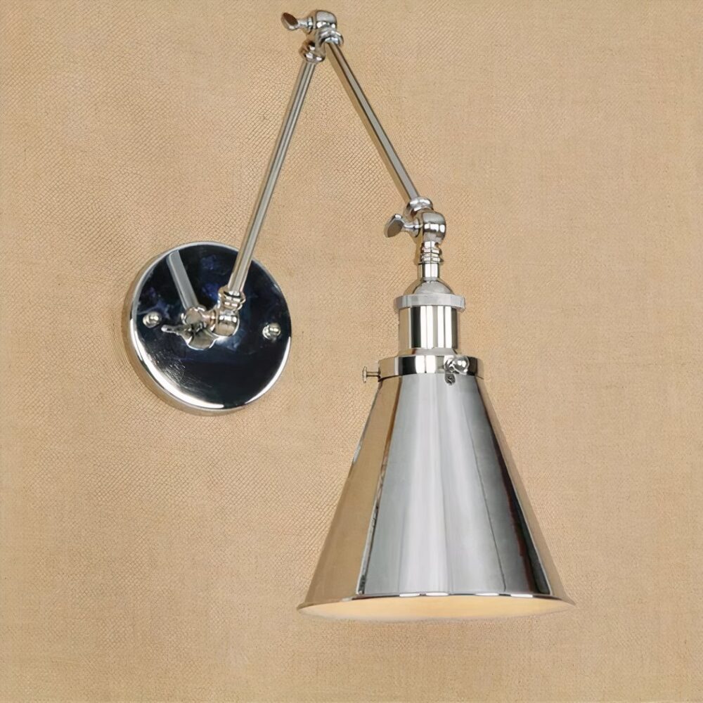 on a brown wall, we see an industrial vintage-style silver wall light with a folding arm
