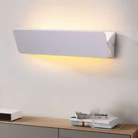 Modern white wall light with adjustable flap on white background.