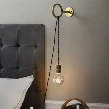 Wired wall light vintage style bulb Wall-mounted wired light on a bedroom wall