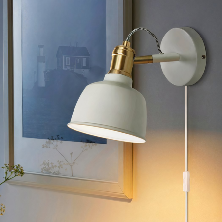 A green wired metal wall light with switch
