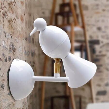 in a lotf with a brick wall, we see a minimalist white bird-shaped designer wall light