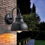 Matte black wall light on brick wall, outdoors