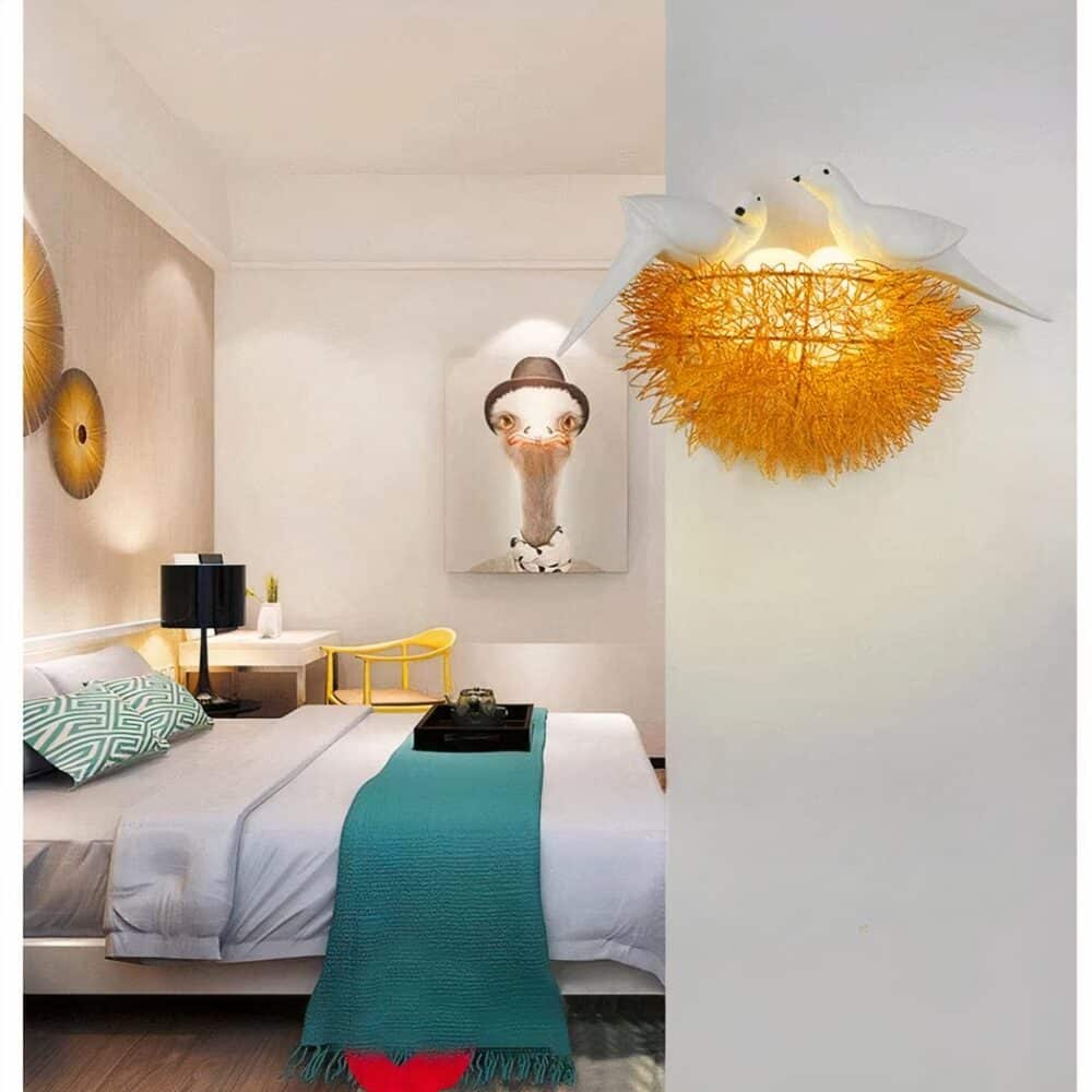 in a room with light-colored walls, a wall light in the shape of a nest with its birds can be seen