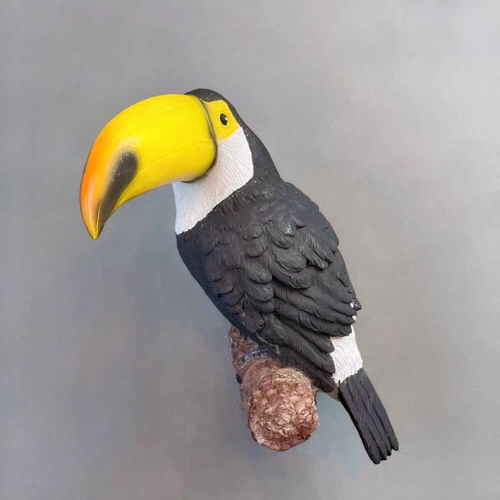 a Toucan-shaped wall lamp is seen on a grey wall