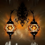A two-headed oriental-style wall sconce with mosaics in every color