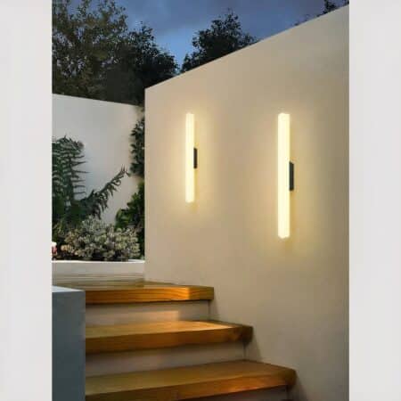 outdoor neon tube wall light mounted on a garden wall along a staircase.