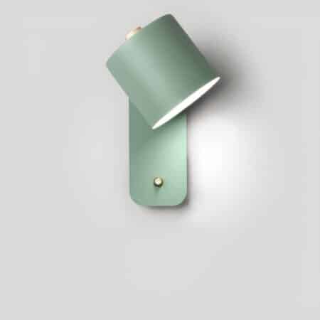 Rectangular vertical wall light with a switch on the bottom and a directional spot lit. Scandinavian-style pastel green. Mounted on a white wall.