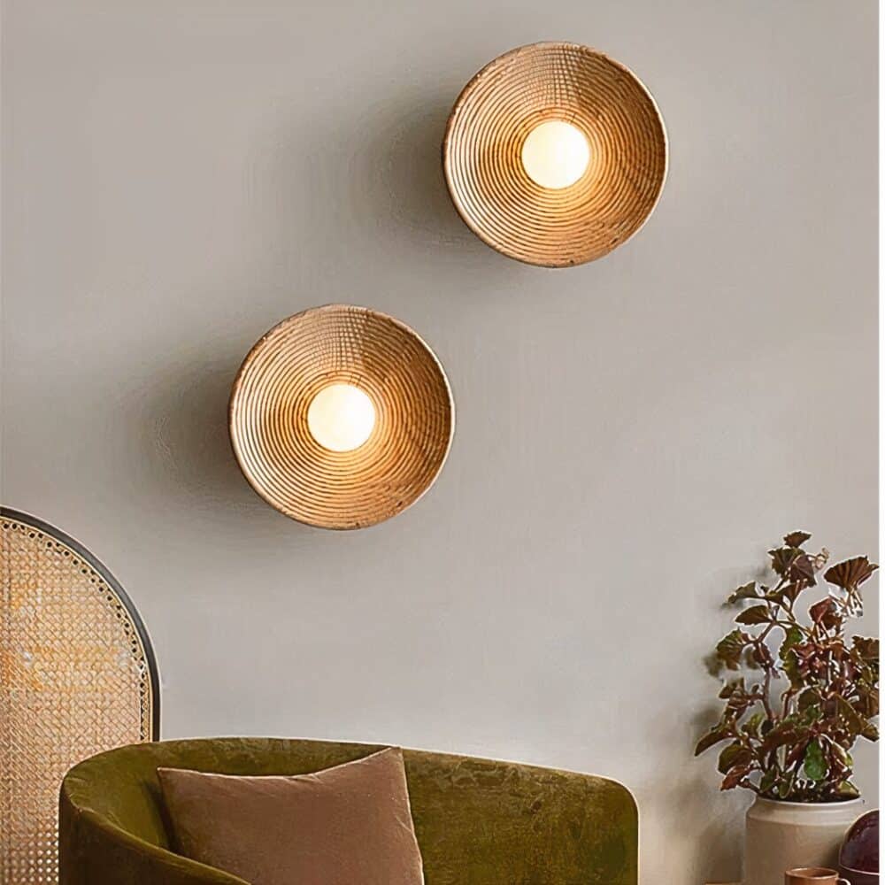in a living room with gray walls, two bohemian-style round wooden wall sconces can be seen