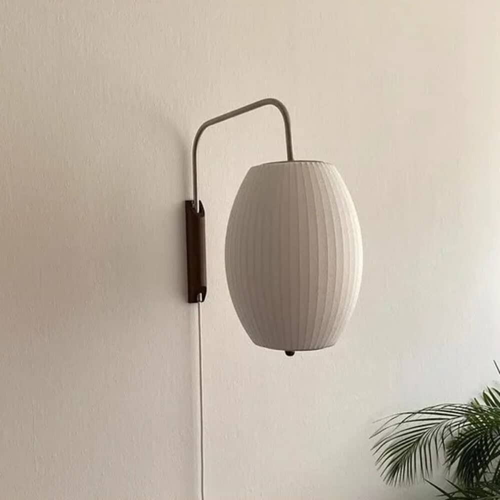 Japanese wall lamp, japandi zen style, in pleated white silk fixed to the wall.